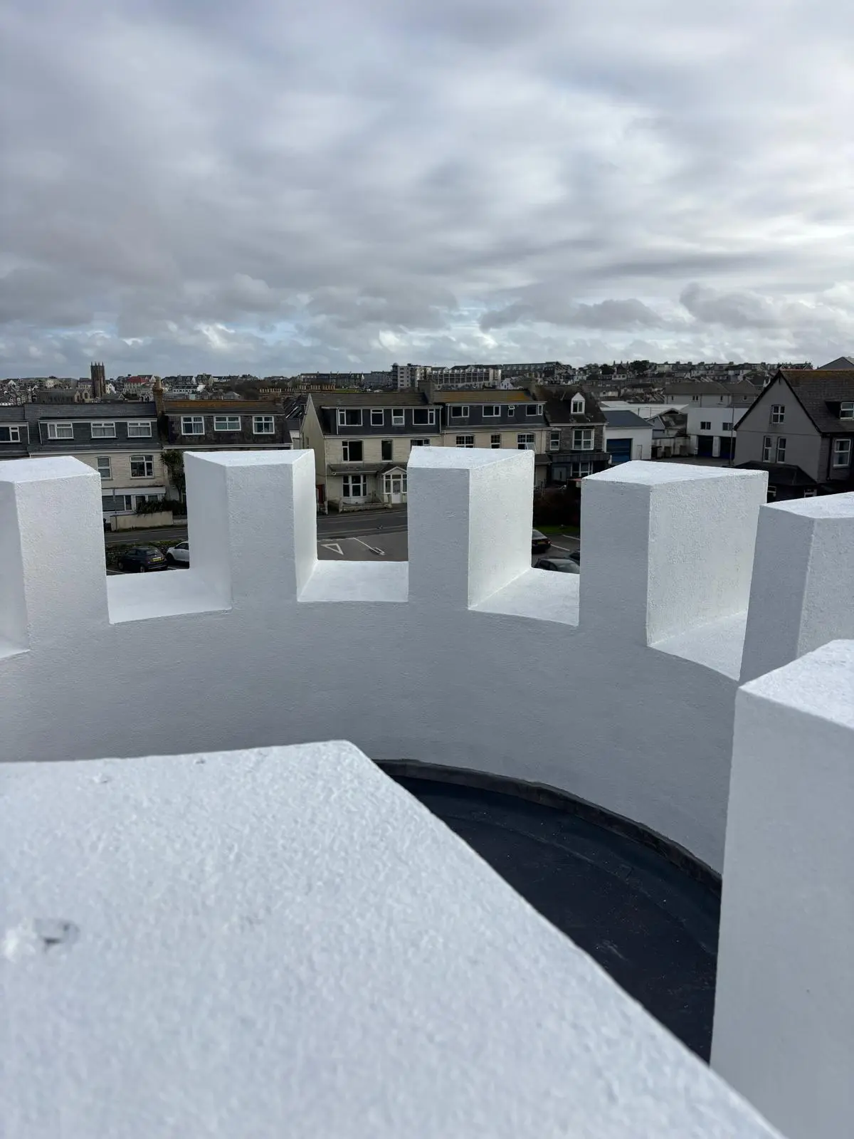 Completed roof covering and repainted parapet walls