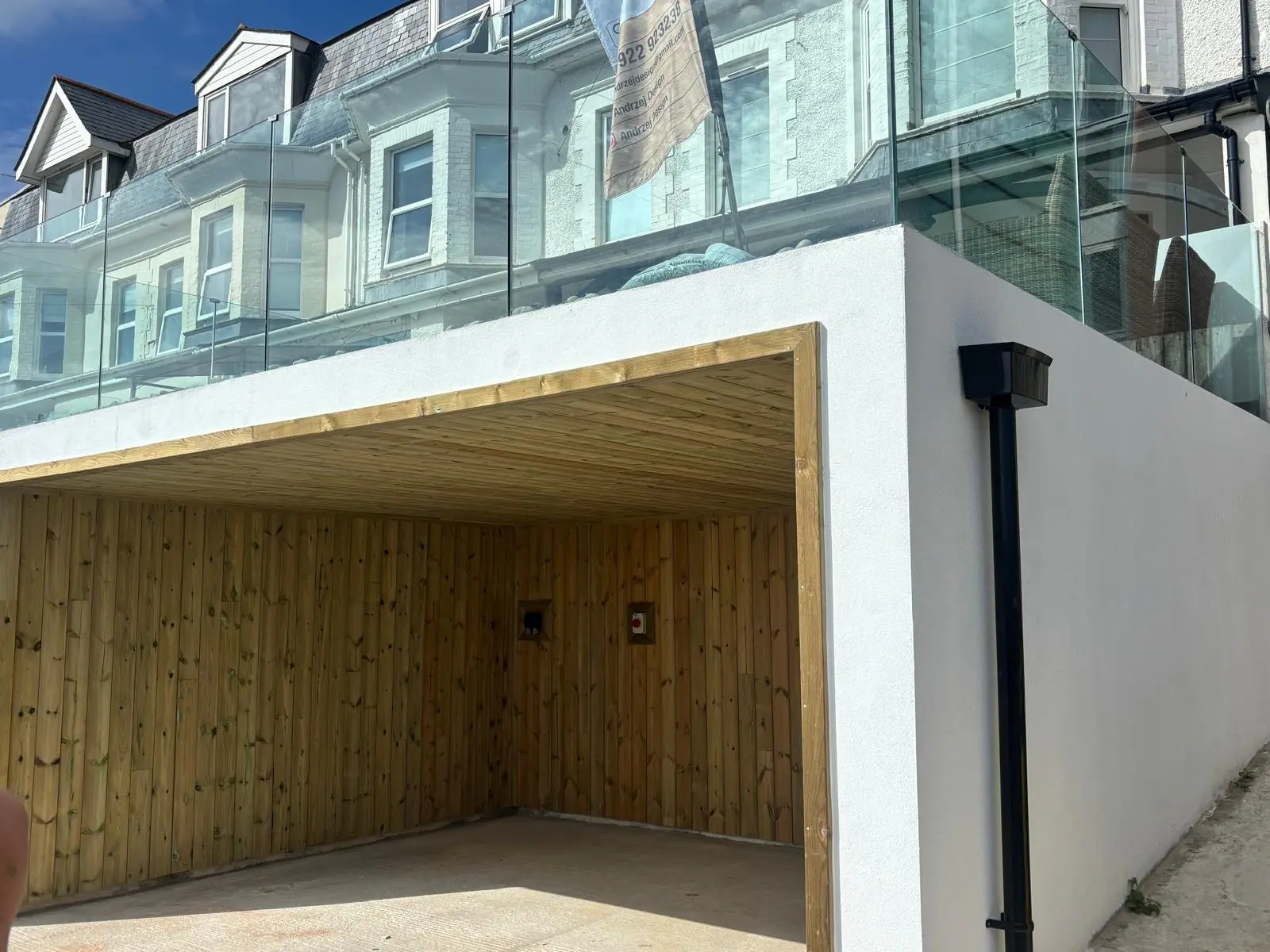 Garage roof with cladding, guttering and downpipe