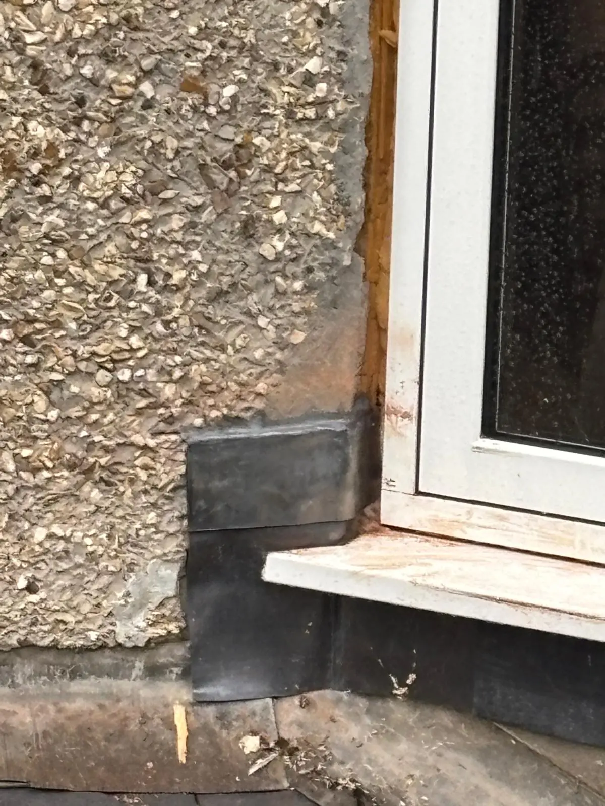Lead flashing installed beneath a window