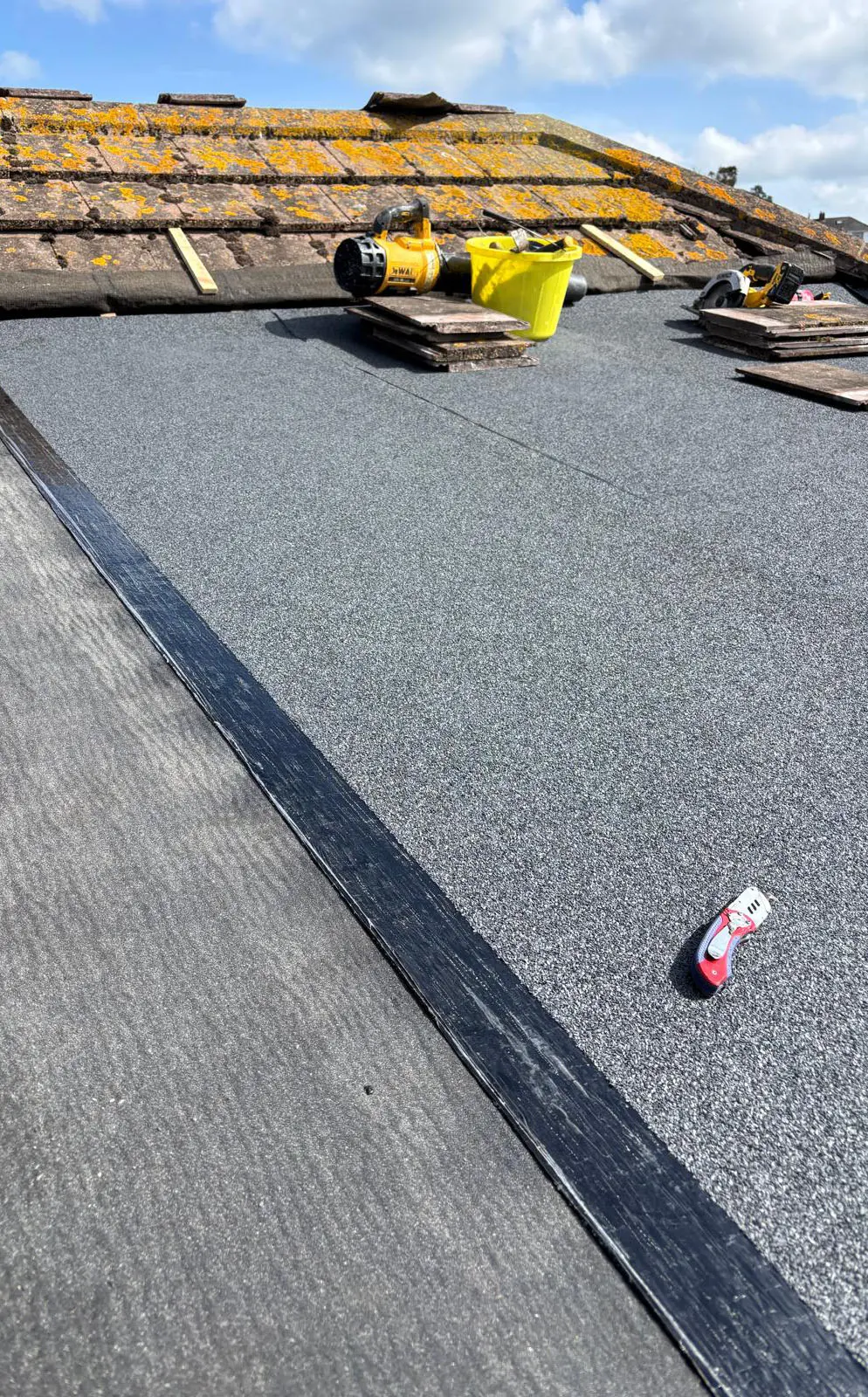 New felt roof meeting an existing tiled roof