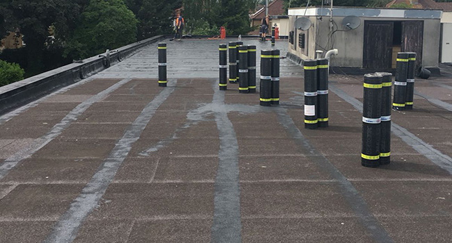 Stripping away the existing covering preparing for the new covering.